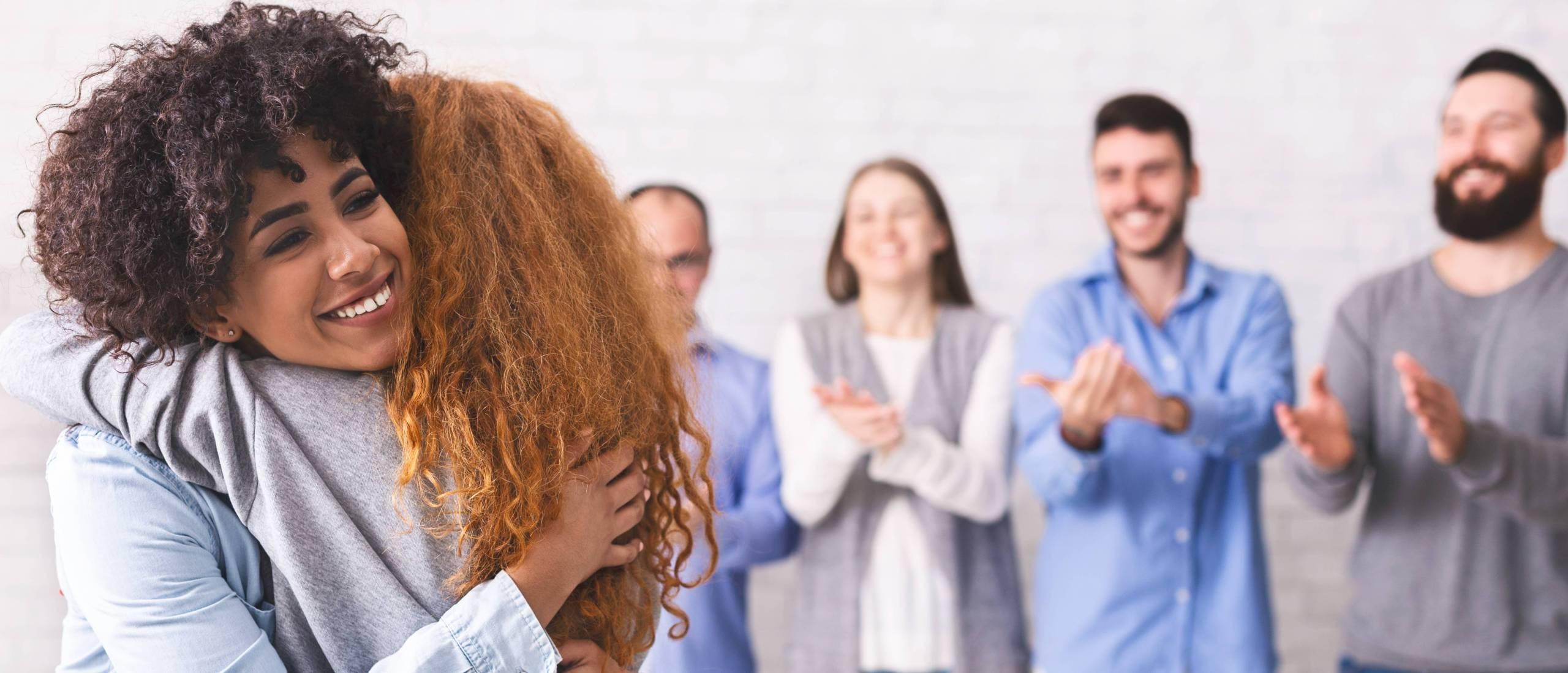 cheerful-people-hugging-during-group-therapy-sessi-2022-12-16-07-36-03-utc