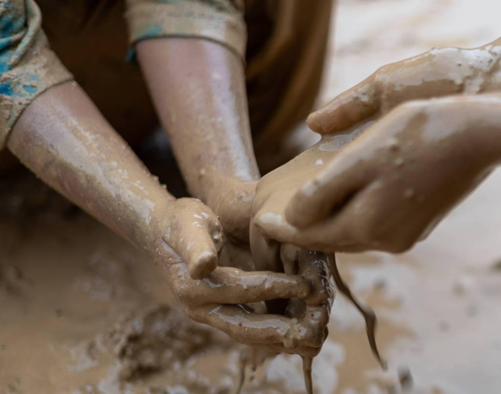 hands-of-children-playing-in-the-mud-2022-12-14-23-54-17-utc